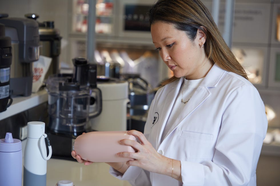 lab analyst evaluating water bottle