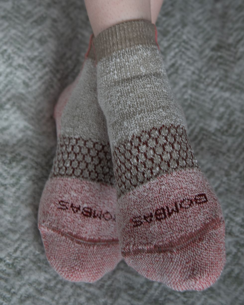 a pair of pale red and beige socks