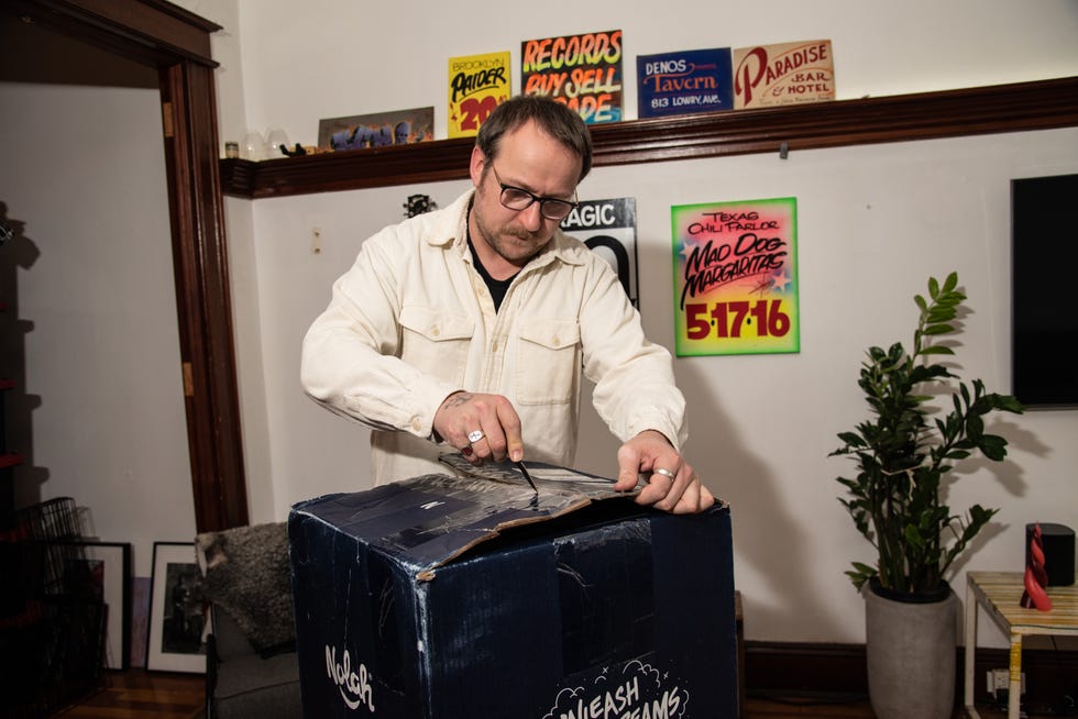 a man unboxes a mattress