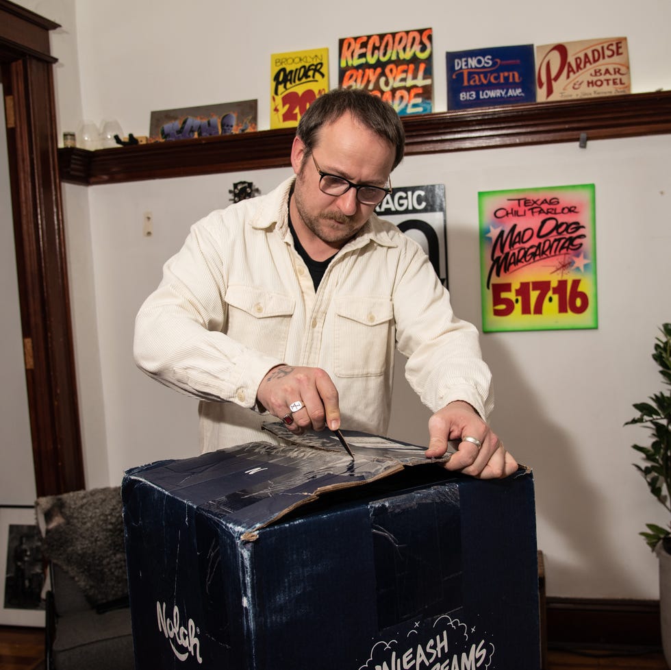 Unboxing a Mattress in Testing a man unboxes a mattress