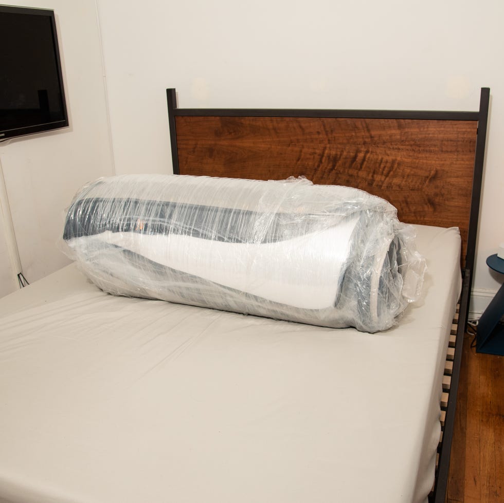 best mattress for side sleepers - mattress unboxing a rolled mattress on a bed