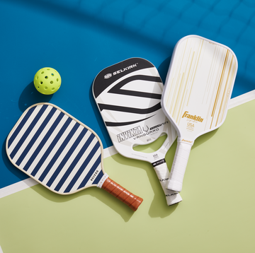 three of the best pickleball paddles on a blue and green background according to good housekeeping