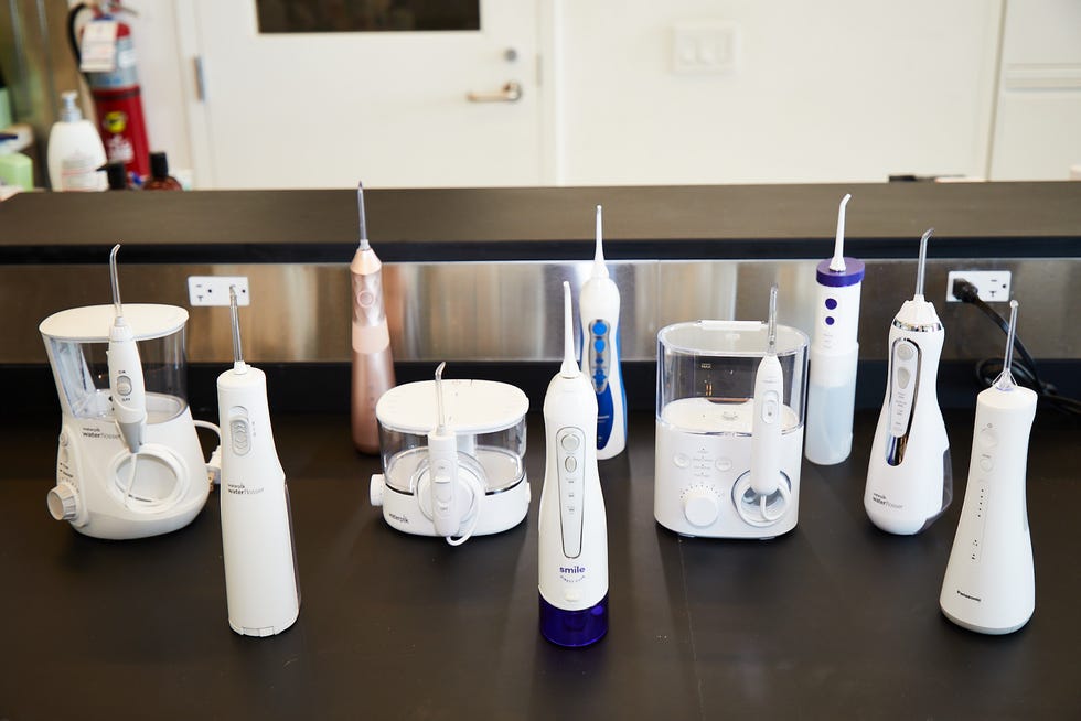 10 water flossers sitting on a lab bench