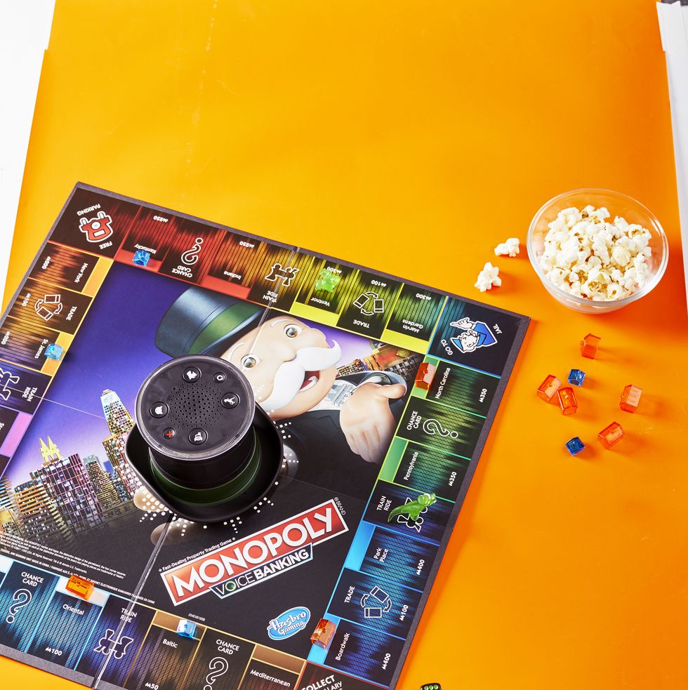 a monopoly board set against an orange background the game is a good housekeeping pick for best board games