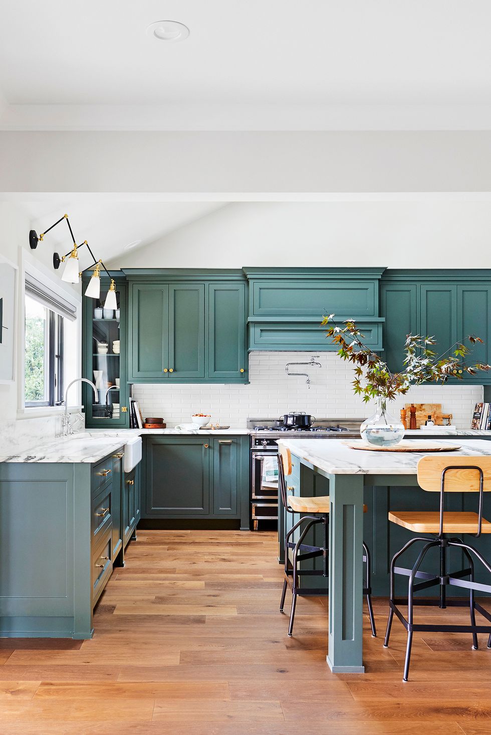 Sage green kitchen cabinets in a green color palette apartment