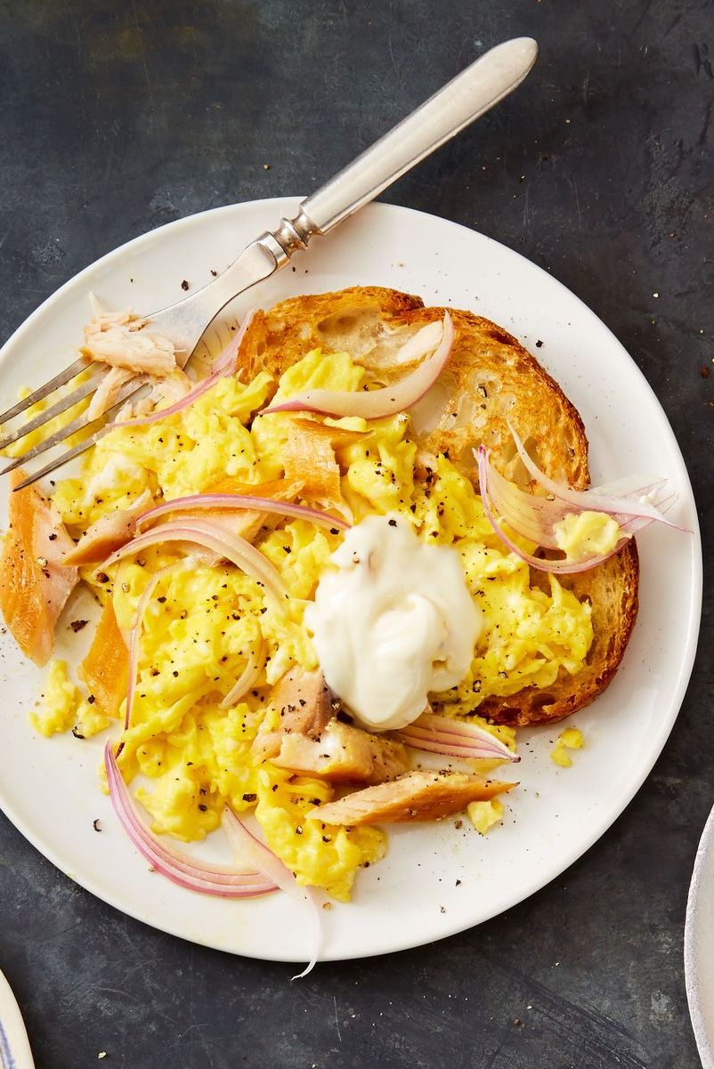 scrambled eggs with smoked trout and creme fraiche on top