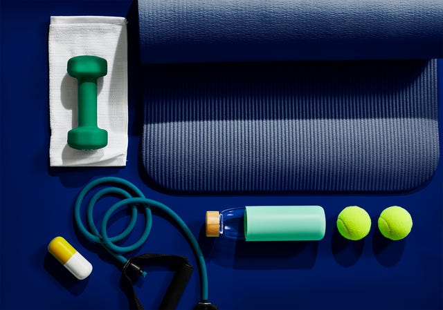 flat lay of exercise equipment on dark blue background