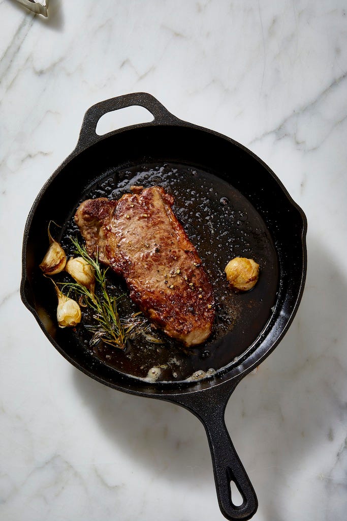 new york strip steak in a cast iron pan