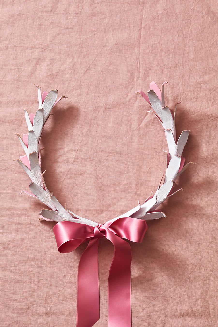 a wreath with a pink bow