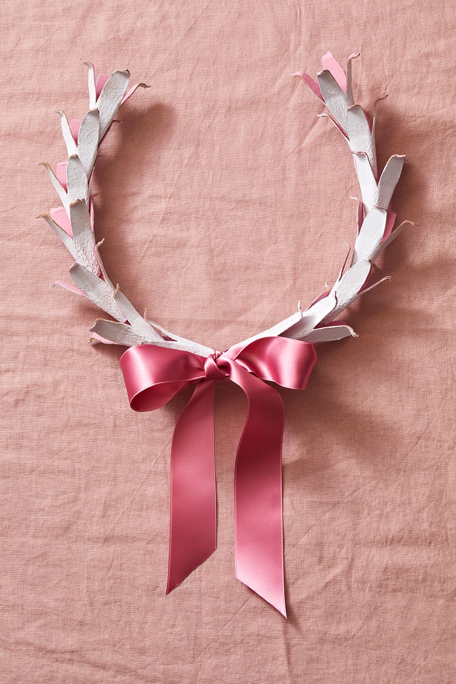 a wreath with a pink bow