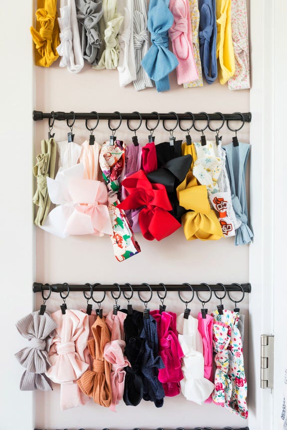 designer marie cloud of indigo pruitt used tension rods and curtain rings to hang bows in her daughter's bedroom child's bedroom