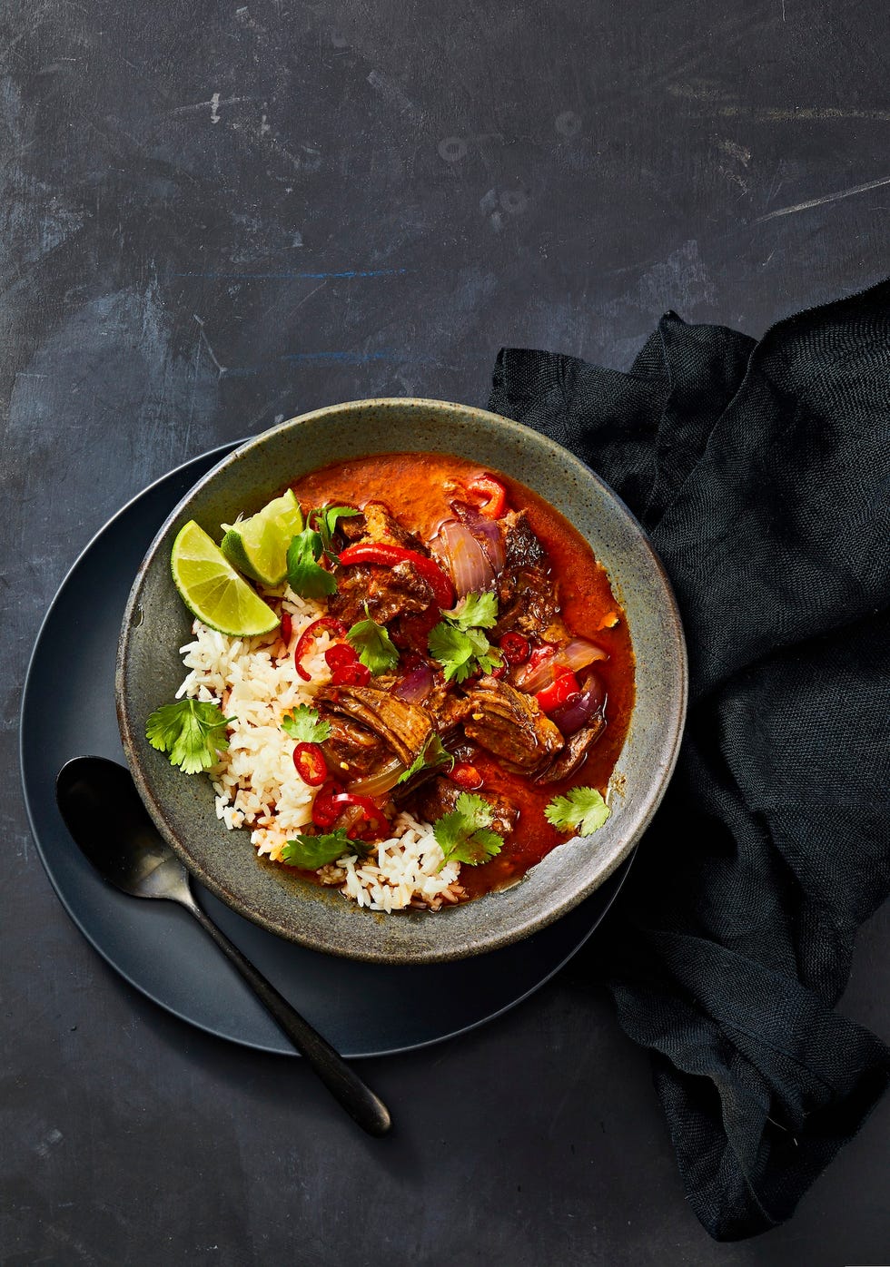 coconut beef curry over white rice in a bowl