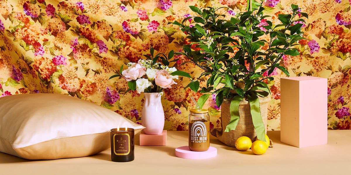 mothers day gifts on beige surface with floral background mothers day gifts on beige surface with floral background