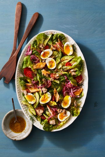 smoked trout salad boiled eggs, onions, sliced avocados and tomatoes seafood