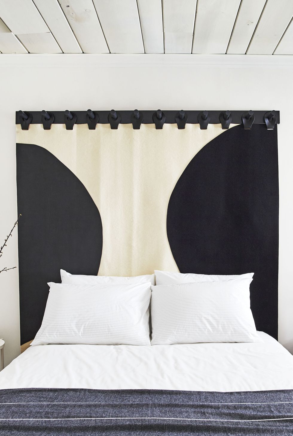 bedroom with curtain as a headboard
