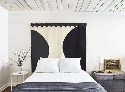 bedroom with curtain as a headboard