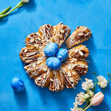 cinnamon swirl bread with icing drizzled and blue chocolate eggs on top