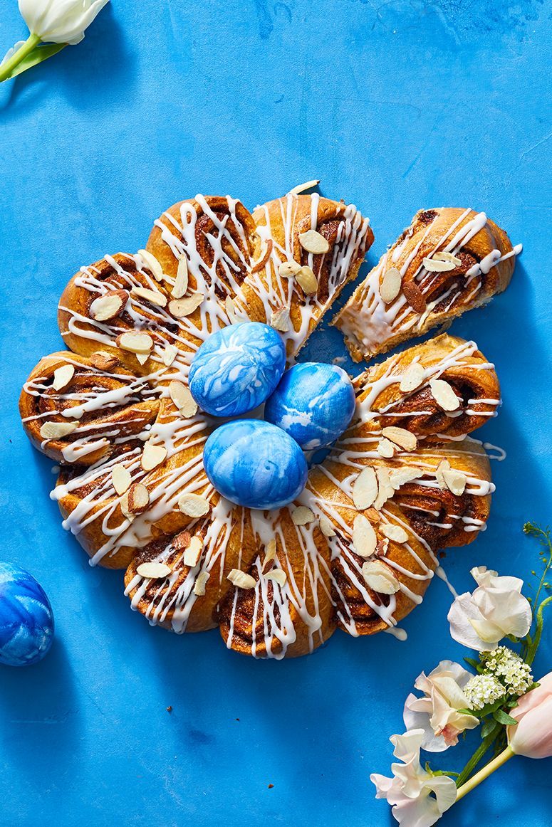 cinnamon swirl ring cake with sliced almonds, icing and blue died eggs on top