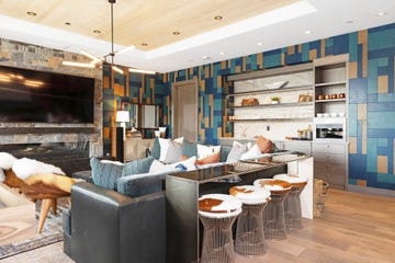 basement with custom sectional, portable ottomans and stools that can be tucked under the bar height table lindsey treasure of alder  tweed