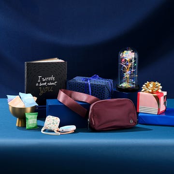 gift items arranged on a blue surface including a book decorative boxes and a storage bag gift items arranged on a blue surface including a book decorative boxes and a storage bag