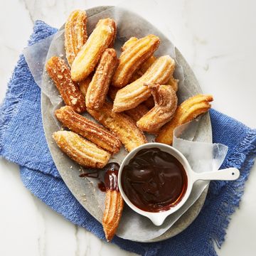 cinnamon churros with dipping chocolate on the side