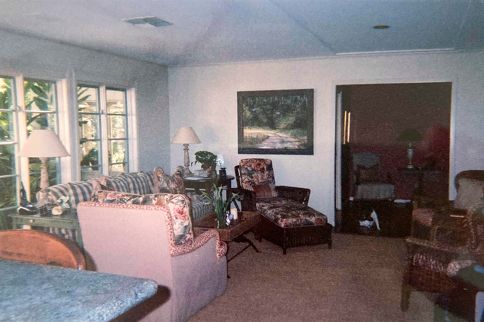 living room with windows and floral and plaid sofas