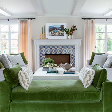 neutral living room with green bench and fireplace mantel