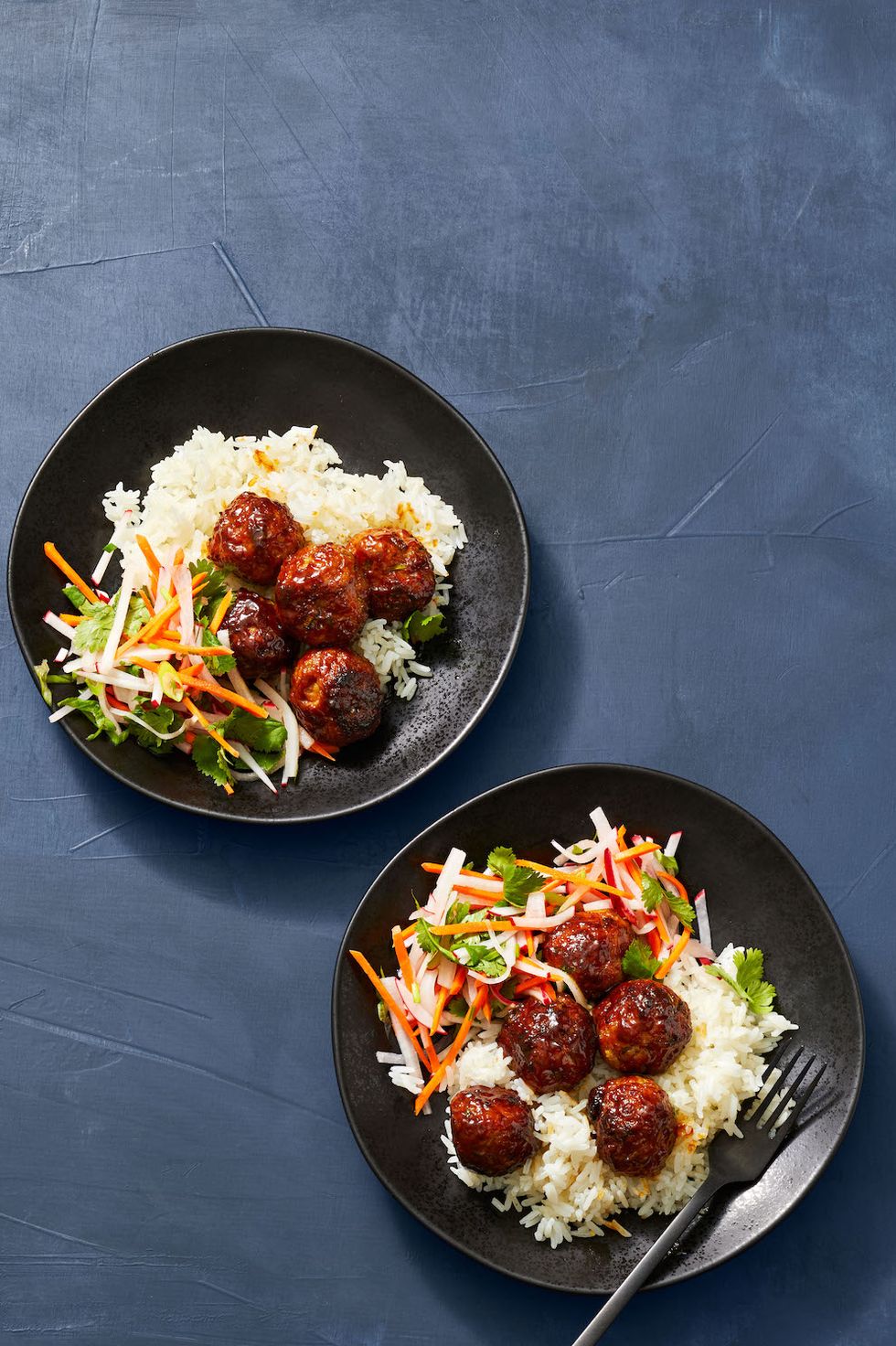 two bowls of rice with banh mi glazed pork meatballs