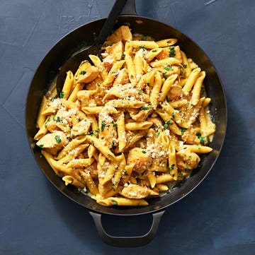 Chicken Francese Pasta chicken francese pasta in a skillet on blue surface