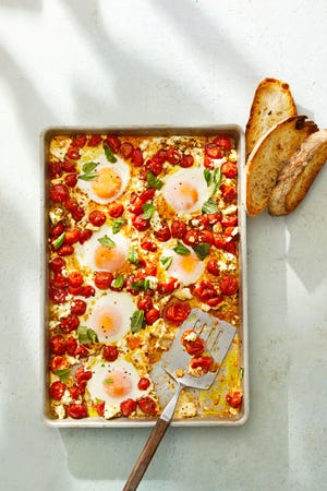 tomato and feta baked eggs on a sheet pan