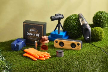 fathers day gifts such as whiskey smoker, binoculars and speaker on faux grass