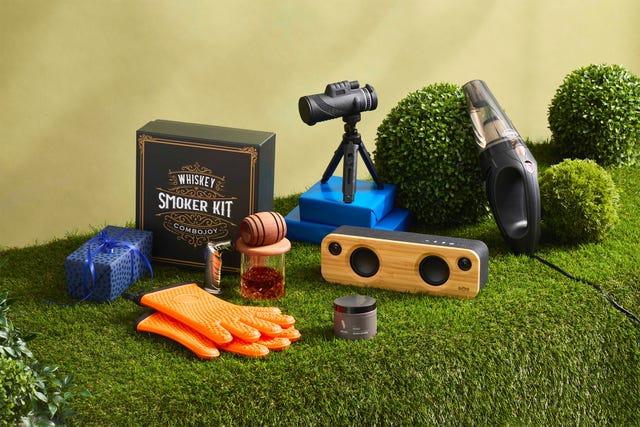 fathers day gifts such as whiskey smoker, binoculars and speaker on faux grass