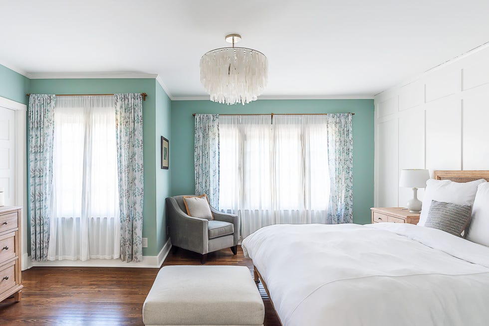 bright bedroom with a year round beach vibe blue accent wall, white linens