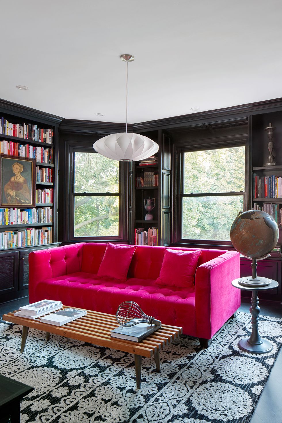 living room library with hot pink couch