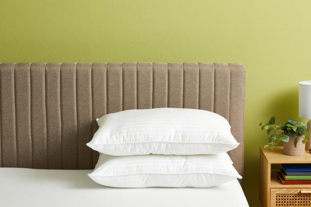 a bed with a white pillow