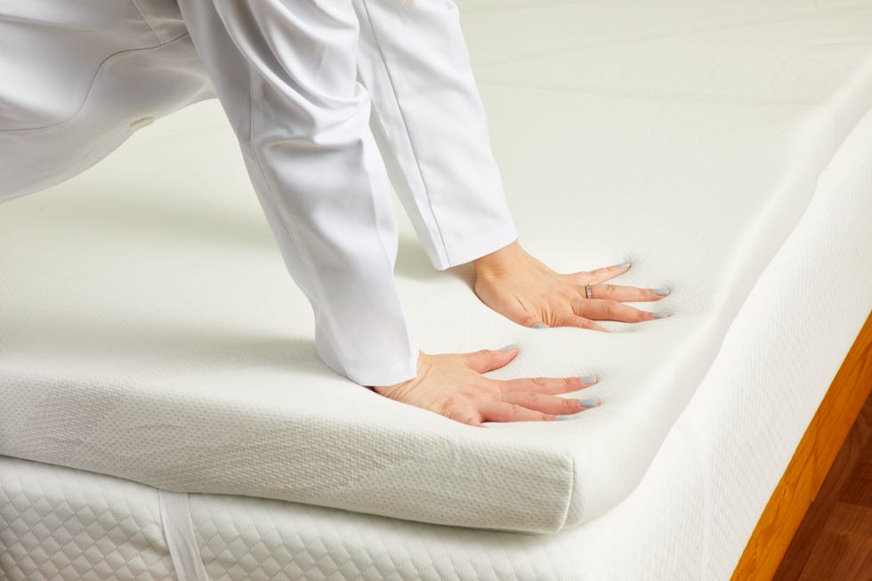 two hands pressing against a topper