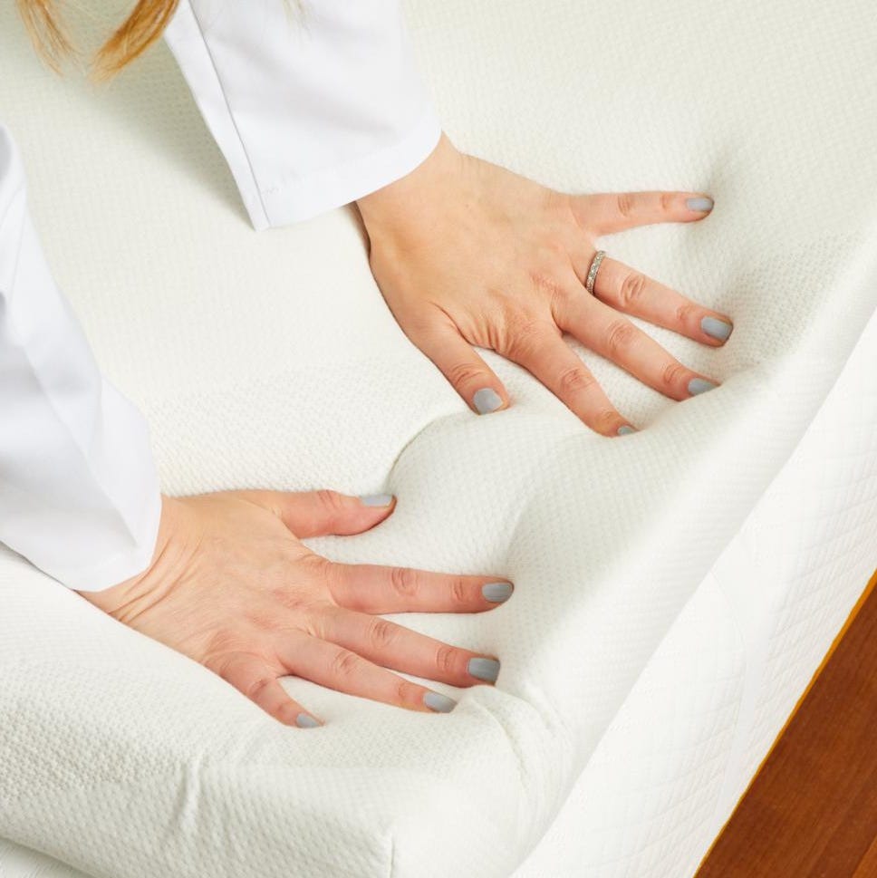 best memory foam mattress toppers a gh analyst pressing down on a memory foam mattress topper