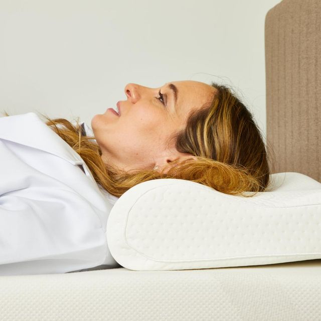 a person lying on a bed with a pillow