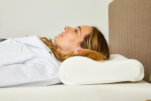 a person lying on a bed with a pillow