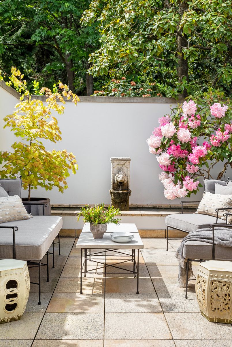 Patio with table with chairs and flowers