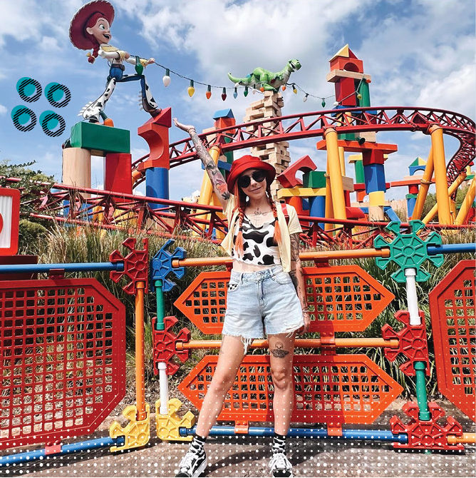 leslie kay stands in front of the slinky dog dash dressed as jessie the cowgirl