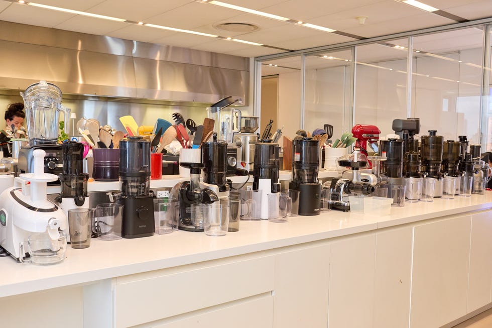 a variety of tested juicers on the countertop