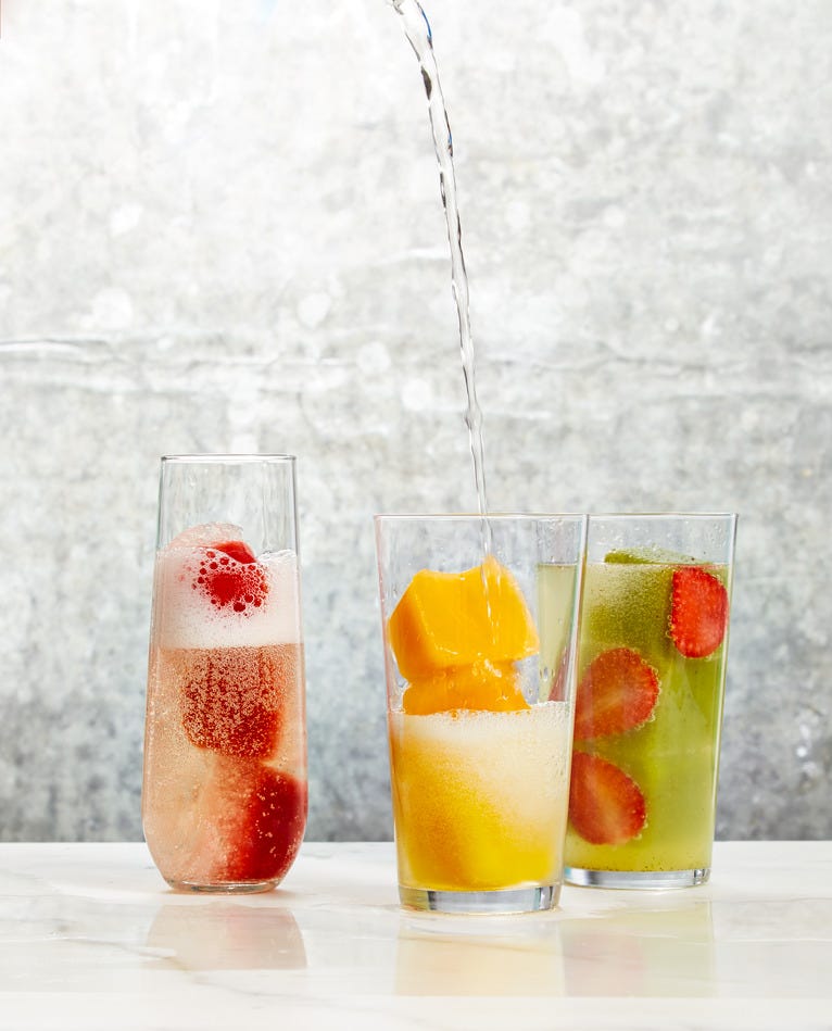 fruit ice cubes in a glass of prosecco
