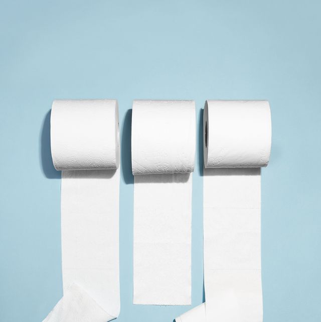 three rolls of toilet paper unrolling against a light blue background