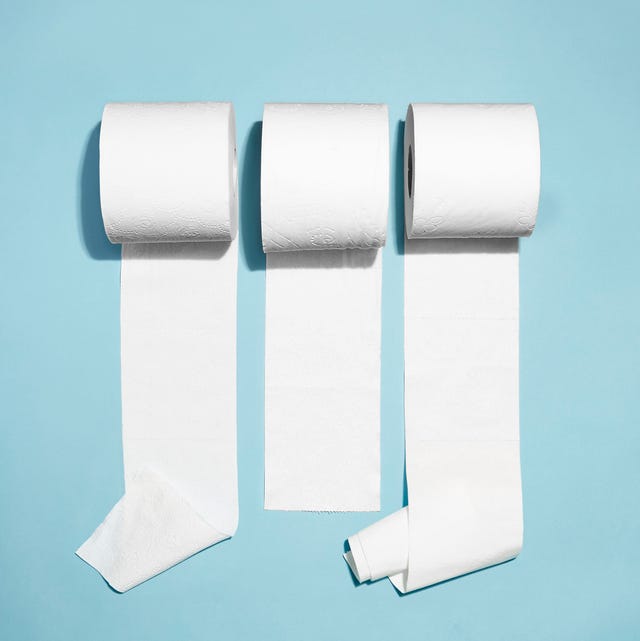 three rolls of toilet paper unrolling against a light blue background