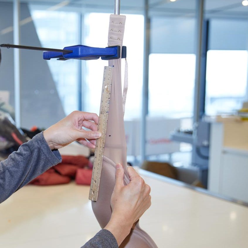 an analyst measuring stretch recovery for a bra