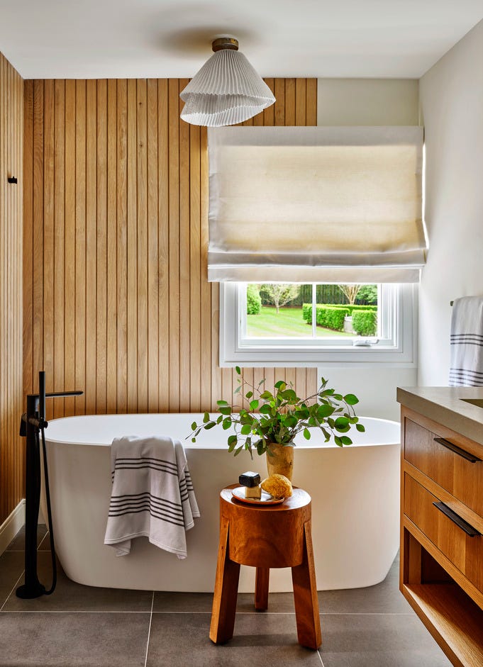 zen bathroom with wood paneling and soaking tub