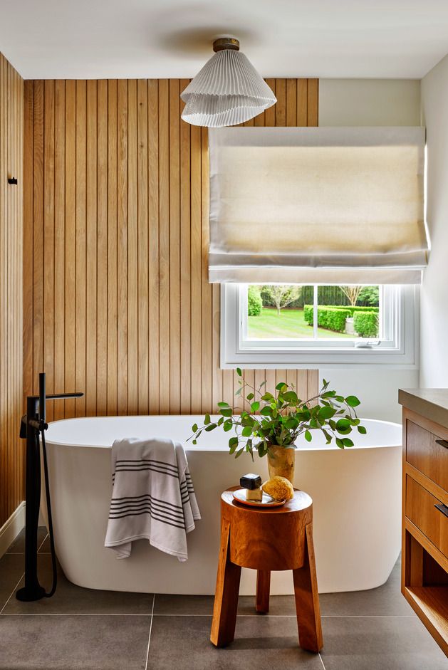 bathroom, soaking tub, japanese inspired bathroom, offcenter wood paneling frames the tub, increasing its zen feel