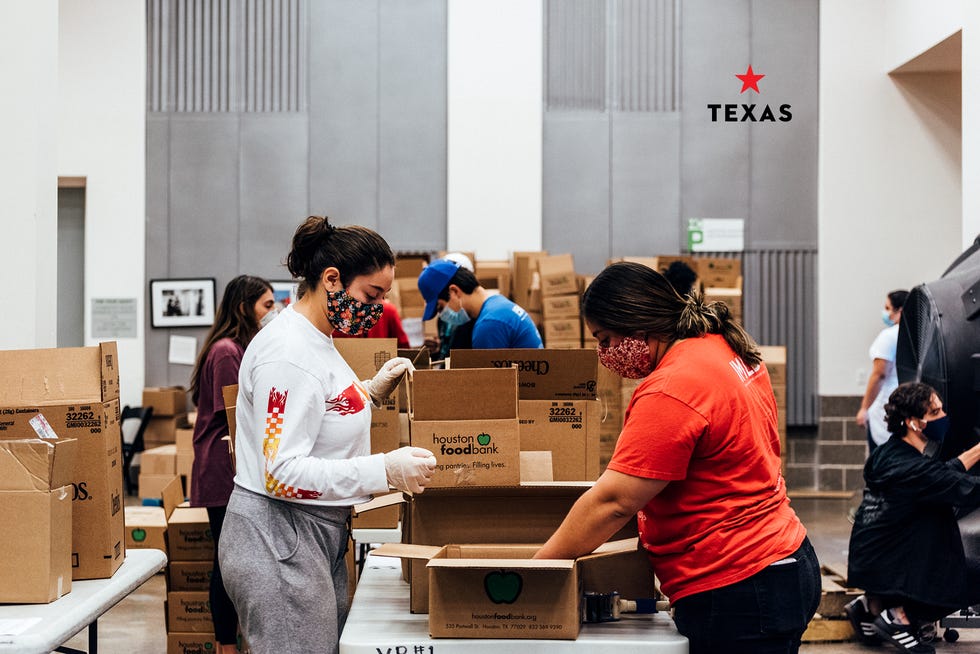 two women packing boxes at houston food bank