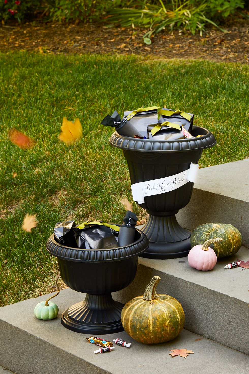 diy outdoor halloween decorations, candy urns outside with candy inside